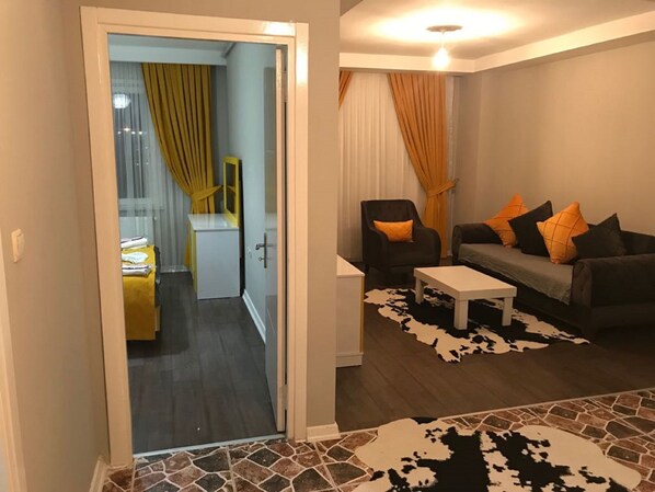 Deluxe Double Room | Living room | Flat-screen TV