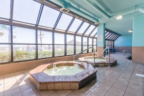 A spa area with two hot tubs and a large windowed wall. - Phoenix V 202 (Orange Beach)