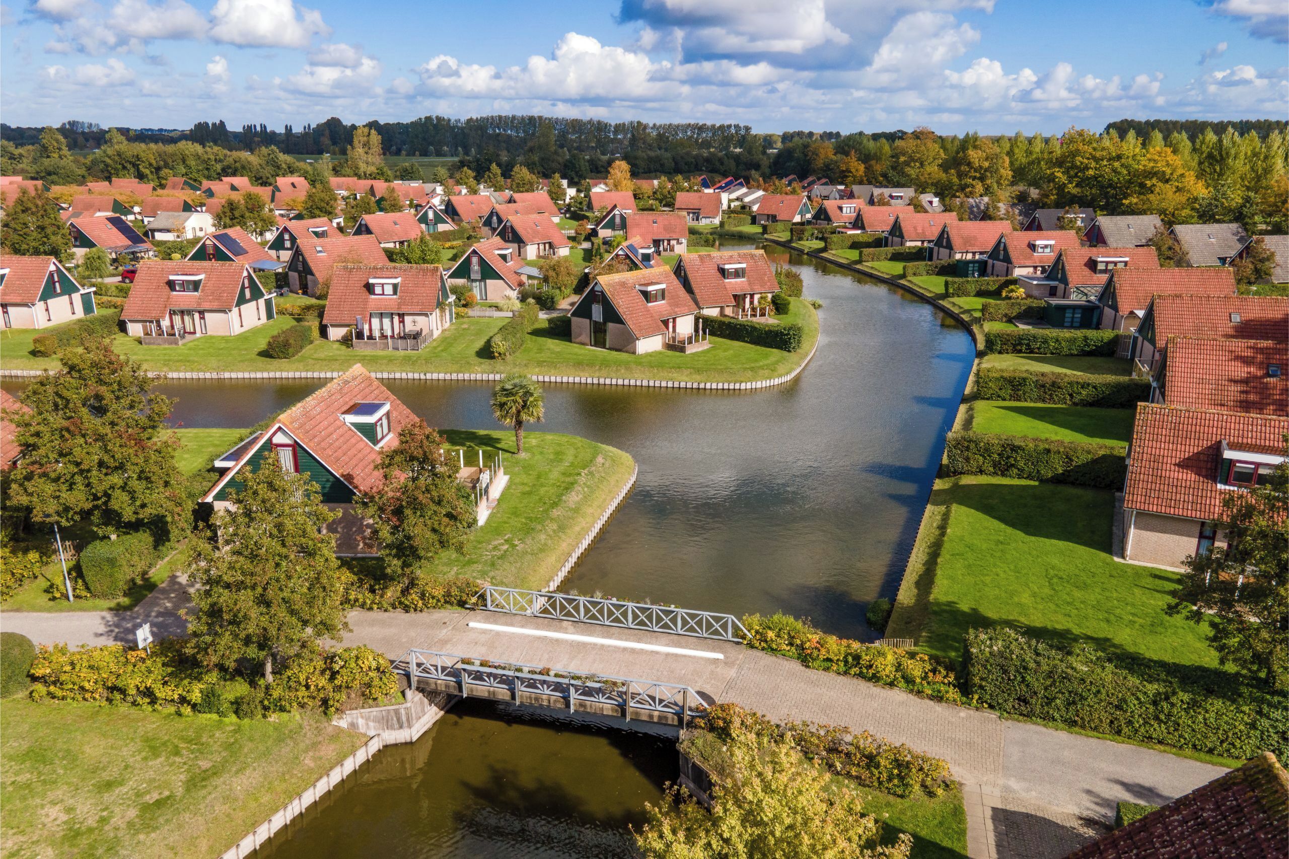 A riverside residential area with houses, a bridge, and a canal.