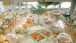 A buffet setup with various food items and a tented outdoor seating area. - Trilocale classic - Two Bedroom Apartment, Sleeps 5 (Porto Azzurro)