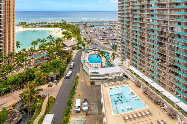 A resort with a pool, beach, and ocean view.