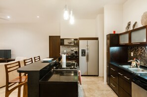 Enjoy cooking in this well-equipped kitchen with a central island, oven, and microwave.