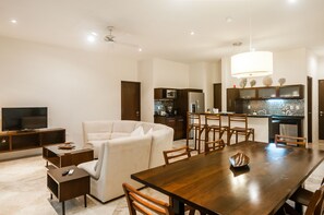 Enjoy meals at the dining table surrounded by comfortable seating and a large television.