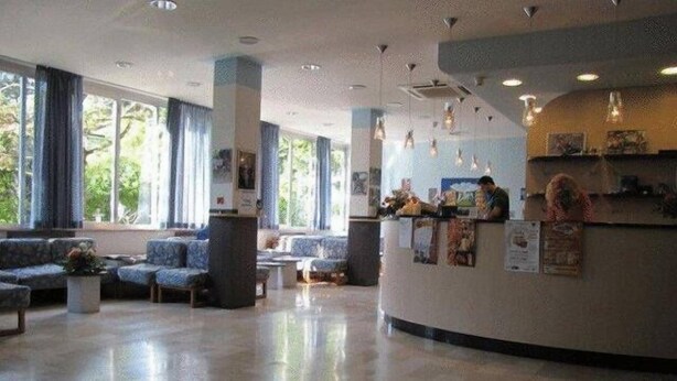 A spacious lobby with a reception desk, seating area, and large windows. - Hotel Senio (Riolo Terme)
