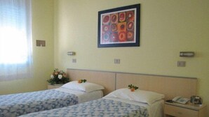 A hotel room with two single beds, a small bedside table with a phone, and a framed artwork on the wall. - Hotel Senio (Riolo Terme)