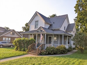 A two-story house with a front porch, a staircase, and a garage. - Downtown Baraboo Blu-Mae Marie Folk House (Baraboo)