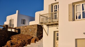 A white building with a stone staircase and a balcony. - Villa Juliet (Mykonos)