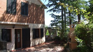 A two-story building with a brick facade and multiple windows with shutters. - La Quercia-Erica - One Bedroom Apartment, Sleeps 5 (Val Canina)