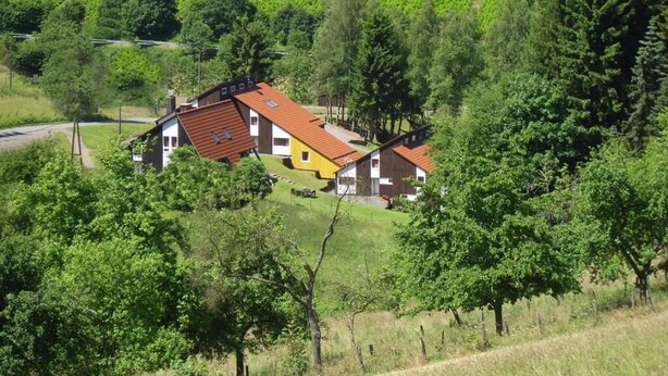 A rural house with a red roof, surrounded by lush greenery and vineyards. - Typ Biberbau - Three Bedroom Resort, Sleeps 6 (Bestwig)