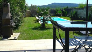 A patio area with a pool, a grill, and a view of the countryside. - House with private pool, not shared between Vaison la Romaine and Nyons (Saint-Maurice-sur-Eygues.)