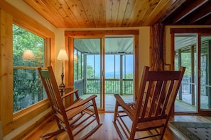Relax in a serene space with a balcony offering views of the surrounding landscape.