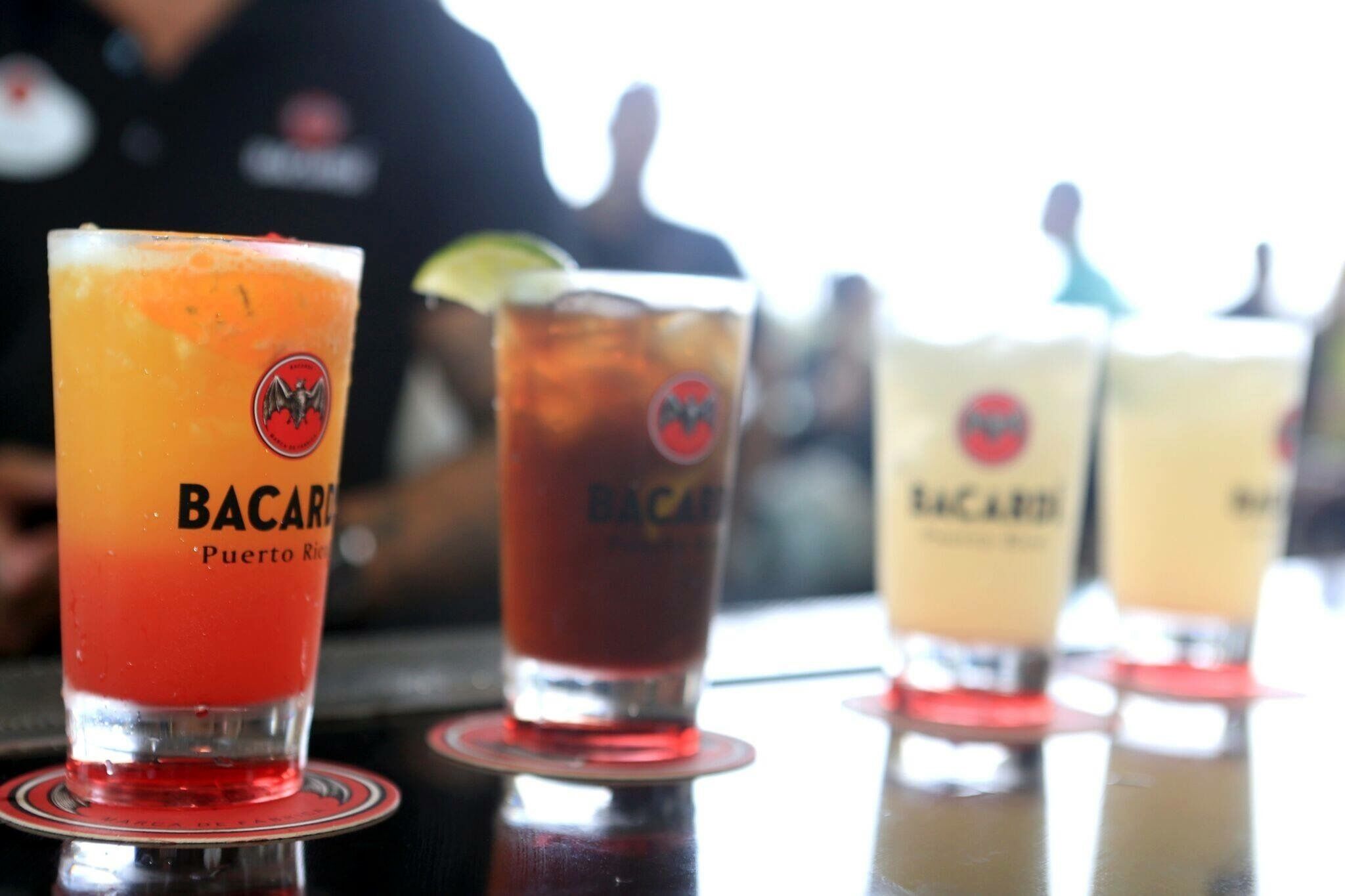 Four Bacardi cocktails on a bar counter.