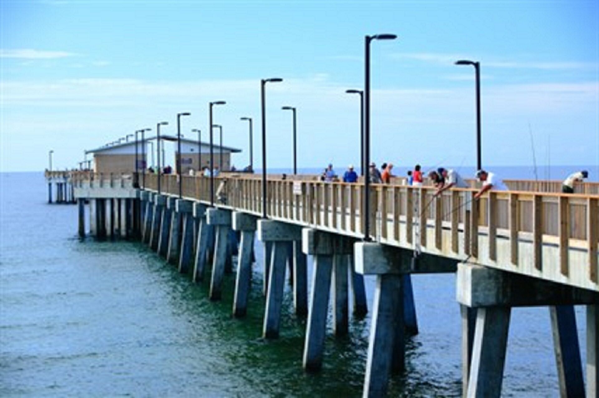 A pier extending into the water with a building at the end.