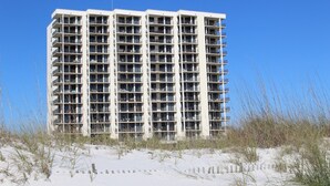 A multi-story hotel with a modern architectural design, featuring numerous balconies and a flat roof. - Fun in the Sun! 3 bdrm/2 Bath Ocean Front Condo with gorgeous views of the Gulf! (Orange Beach)