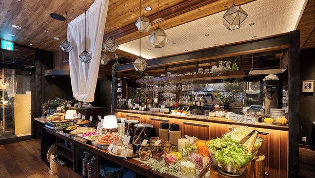 A buffet bar with various food items and a wine selection. - DEL style NAGOYA-NAYABASHI by Daiwa Roynet Hotel (Nagoya)