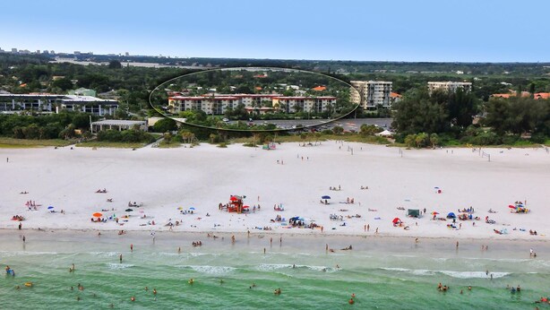 A beachfront hotel with multiple floors, a sandy beach, and a view of the ocean. - Condo# 309 Fully renovated 1b/1b unit with great views of the gulf (Sarasota)