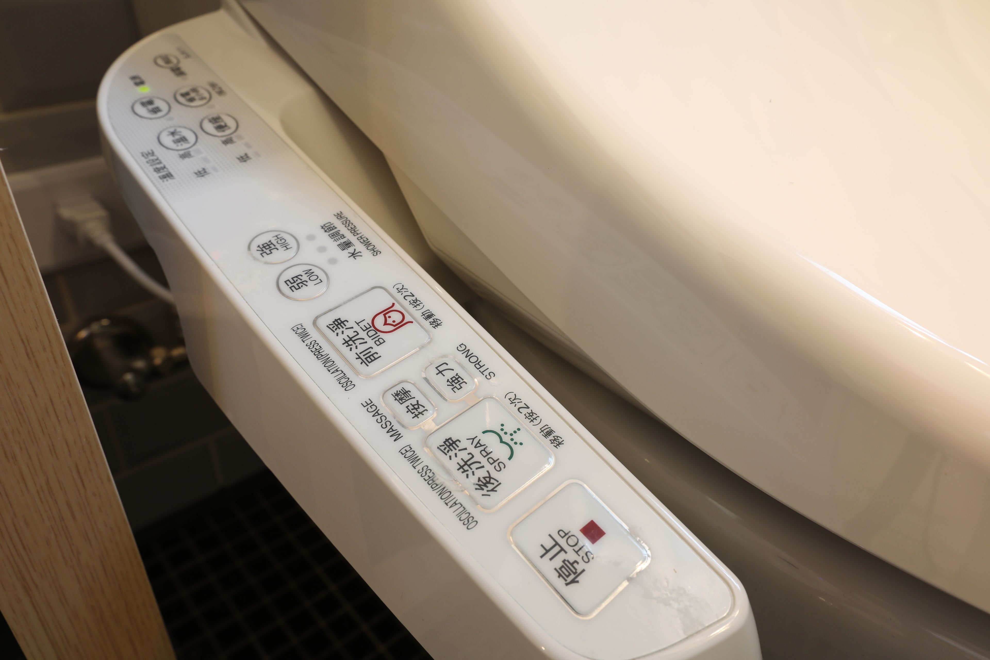A control panel with various buttons and indicators, likely for a bathroom appliance.