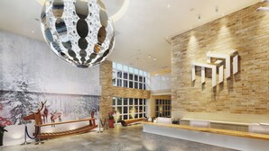 A modern lobby with a reception desk, a large decorative mirror, and a mural of deer on the wall. - Mini Hotels Taichung Station Branch (Taichung)