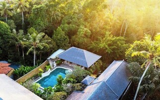 Una piscina al aire libre, sombrillas, sillones reclinables de piscina