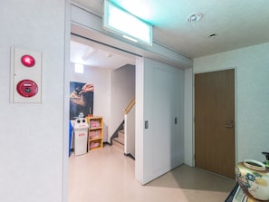 Enjoy a spacious room with a large window, flat-screen TV, and a door leading to another room.