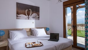 A hotel room with a bed, a laptop, breakfast tray, and a painting of swans. - Villa Arismari - "Oikos-your Cretan house" 5 mins drive from the beach (Aggeliana)