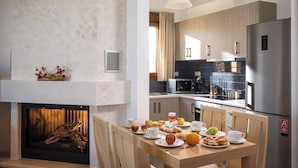 A modern kitchen with a built-in microwave, a stainless steel refrigerator, and wooden cabinets. - Villa Arismari - "Oikos-your Cretan house" 5 mins drive from the beach (Aggeliana)