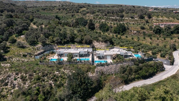 A villa complex with multiple buildings, a swimming pool, and a stone wall. - Kalostous villa 2, Pool,Great location & Views (Agia Triada)