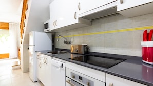 A modern kitchen with white cabinets, a stainless steel sink, a microwave, and a toaster. - INNOUTHOME HOUSE WITH GARDEN AND SWIMING-POOL, BBQ AC AND WIFI,_JUAN DE ALMENARA (L'AMETLLA DE MAR)