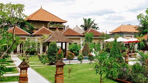 A resort with multiple buildings, a swimming pool, and well-maintained gardens. - Uluwatu Jungle Villa (Pecatu)