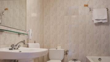 Een bad/douchecombinatie, designer toiletartikelen, een haardroger