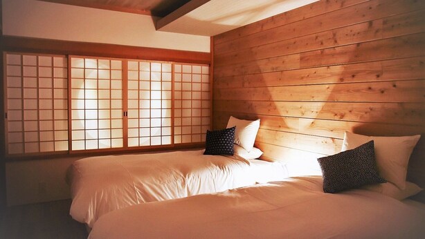 A traditional Japanese-style room with tatami flooring, a low ceiling, and a shoji screen door. - Chika Miyabi (Kyoto)