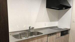 A modern kitchen with stainless steel appliances, a double sink, and wooden cabinetry. - Chika Ichiyin (Kyoto)