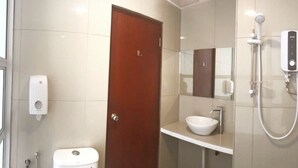 A modern bathroom with a toilet, sink, and shower. - Place2Stay Business Hotel @ Metrocity (Kuching)