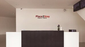 A reception desk with a sign reading "Place2Stay Business Hotel". - Place2Stay Business Hotel @ Metrocity (Kuching)