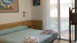 A hotel room with a bed, a chair, a painting, and a view of the outdoors. - Hotel Tre Grazie (Rimini)