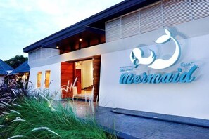 A modern building with a sign that reads "Mermaid Resort."