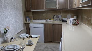 Apartment, 2 Bedrooms | Private kitchen | Fridge, stovetop, dishwasher, coffee/tea maker