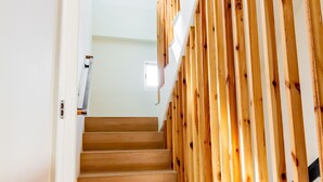 A staircase with wooden steps and a wooden handrail. - Angel Pension (Taitung)
