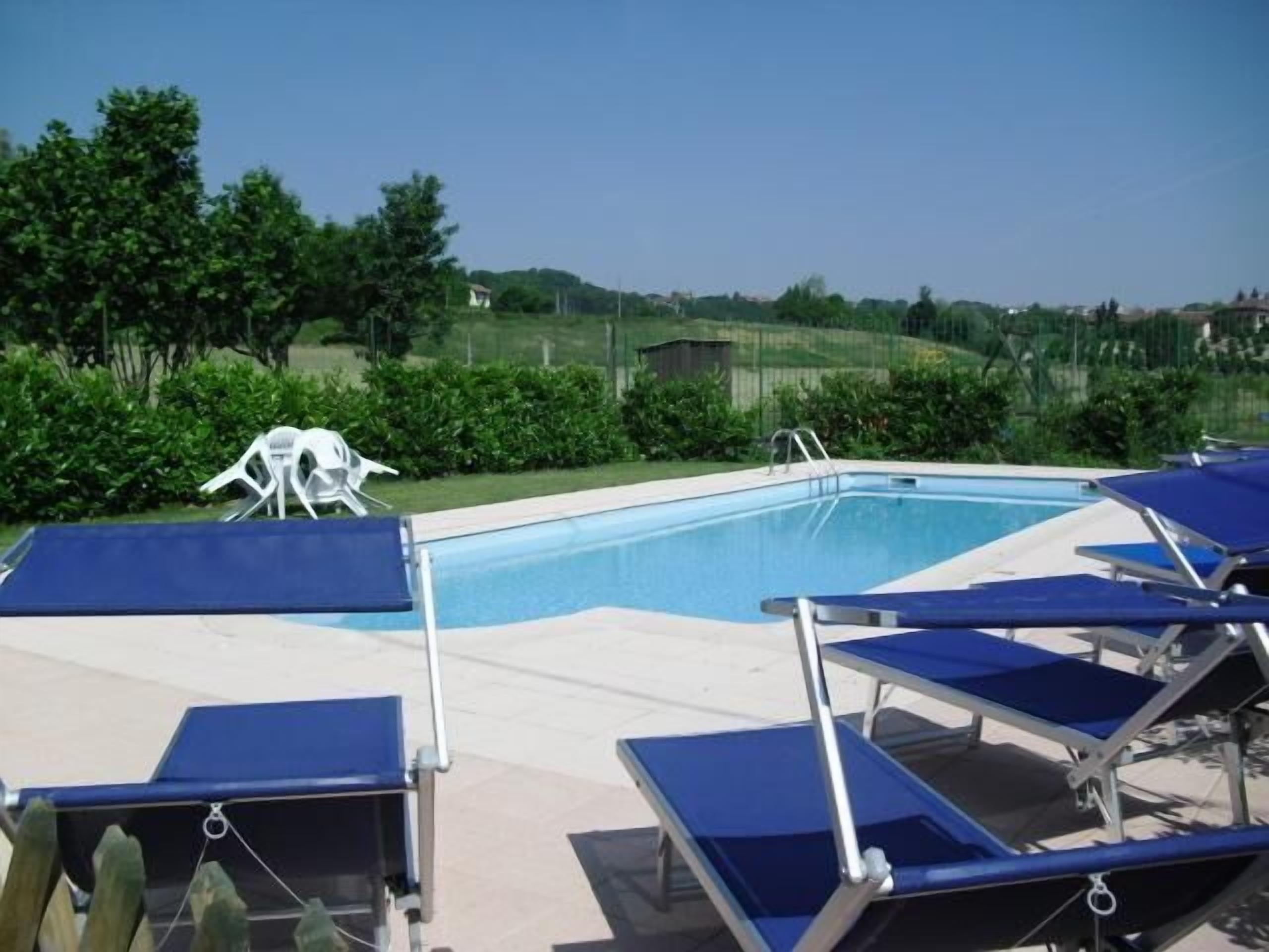 Outdoor pool, a natural pool, pool umbrellas, sun loungers