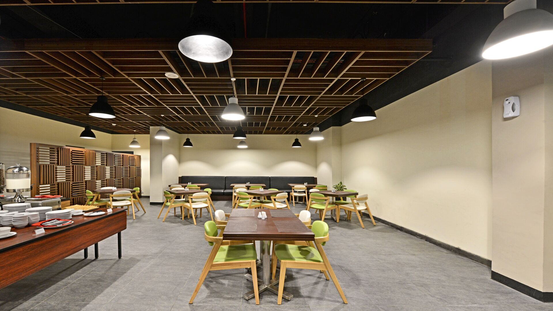 A conference room with a long table, multiple chairs, and a high ceiling with wooden beams.