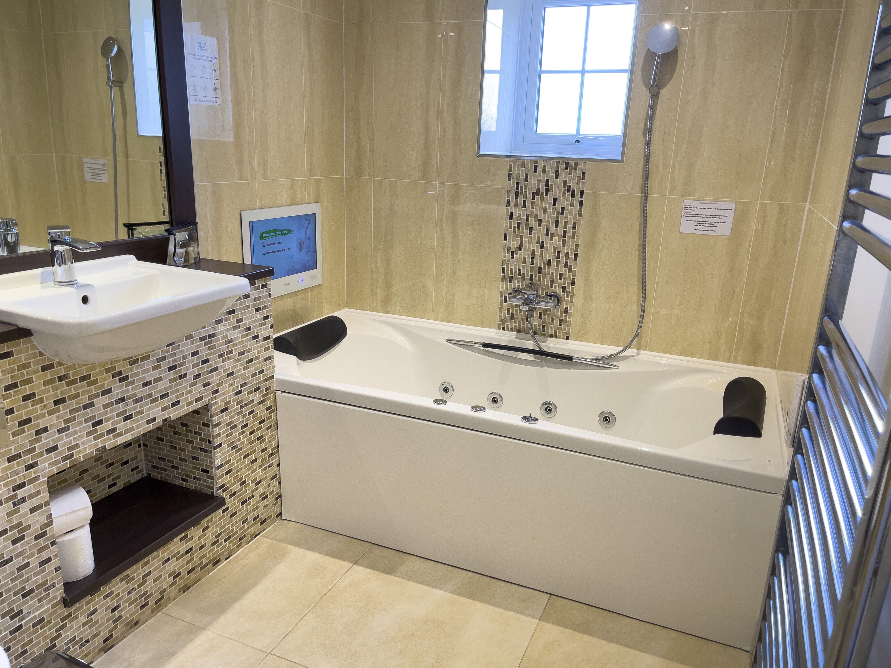 A bathroom with a white sink, a bathtub, and a shower.