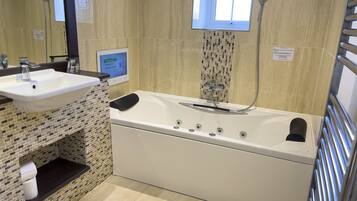 A bathroom with a white sink, a bathtub, and a shower.