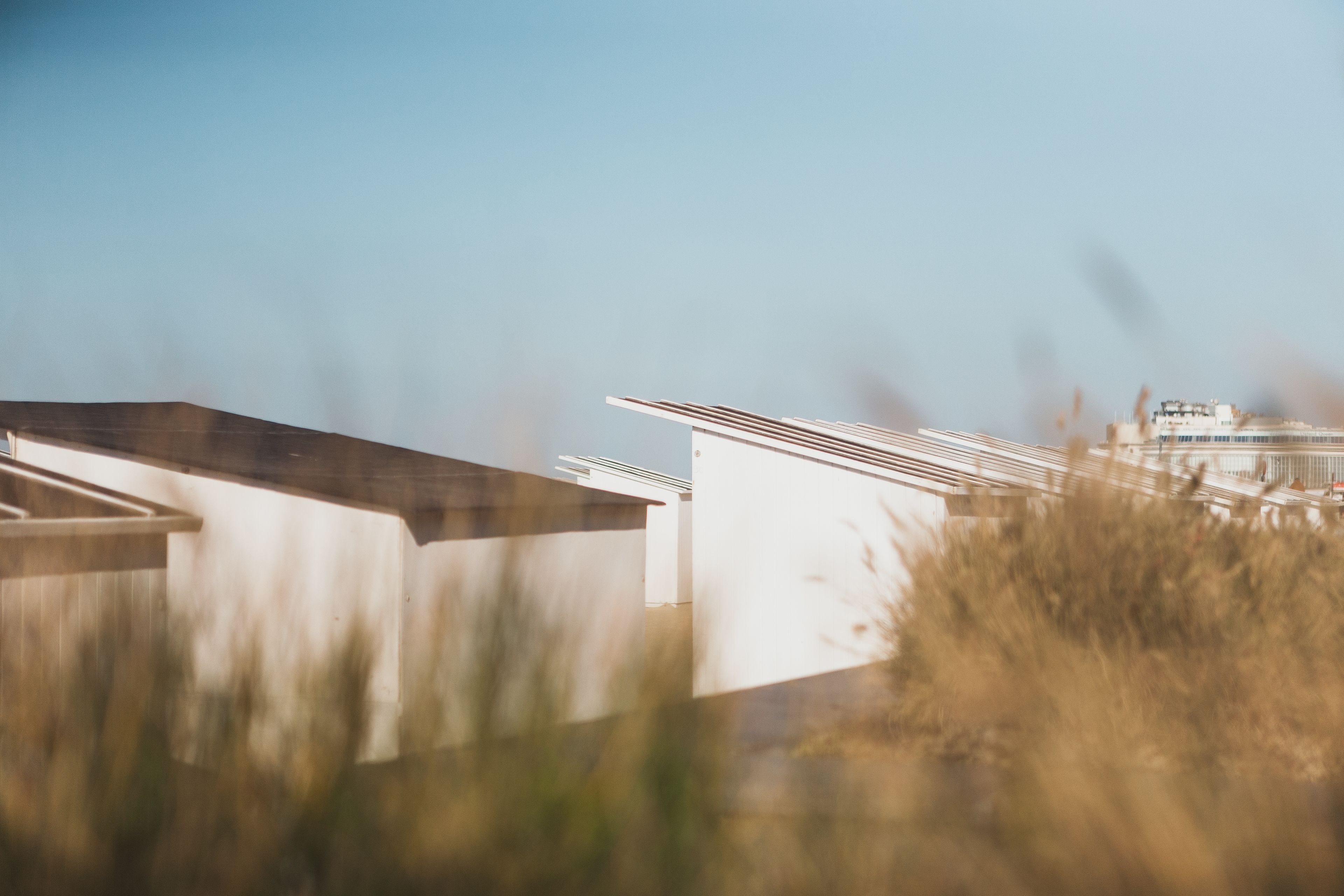 A modern building with a flat roof and white walls.