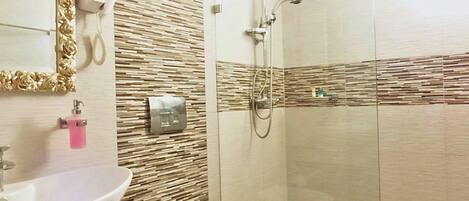 A bathroom with a sink, toilet, and shower.