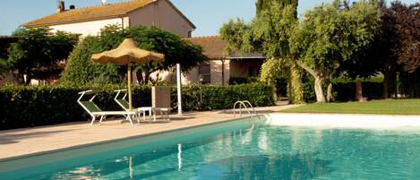 Seasonal outdoor pool, open 7:30 AM to 8:00 PM, pool umbrellas