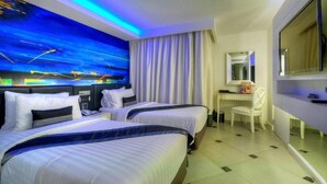 A hotel room with two beds, a desk, a chair, a TV, and a large window with curtains. - Aspira Skyy Sukhumvit 1 (Bangkok)