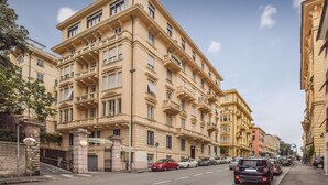 A multi-story building with a classic architectural style, featuring balconies and large windows. - Stunning apartment in Genova (GE) (Genova (GE))