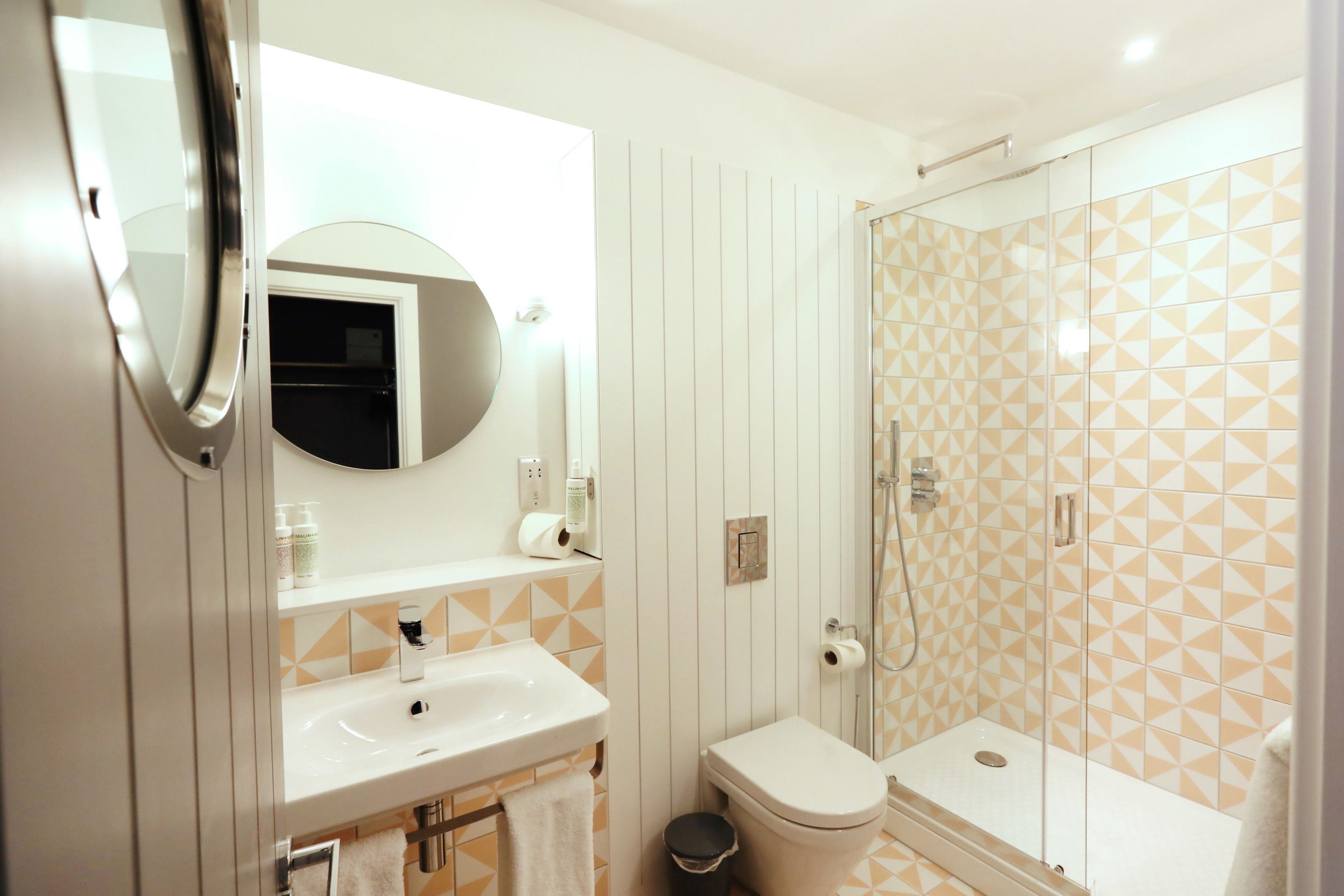 A bathroom with a sink, toilet, and shower.