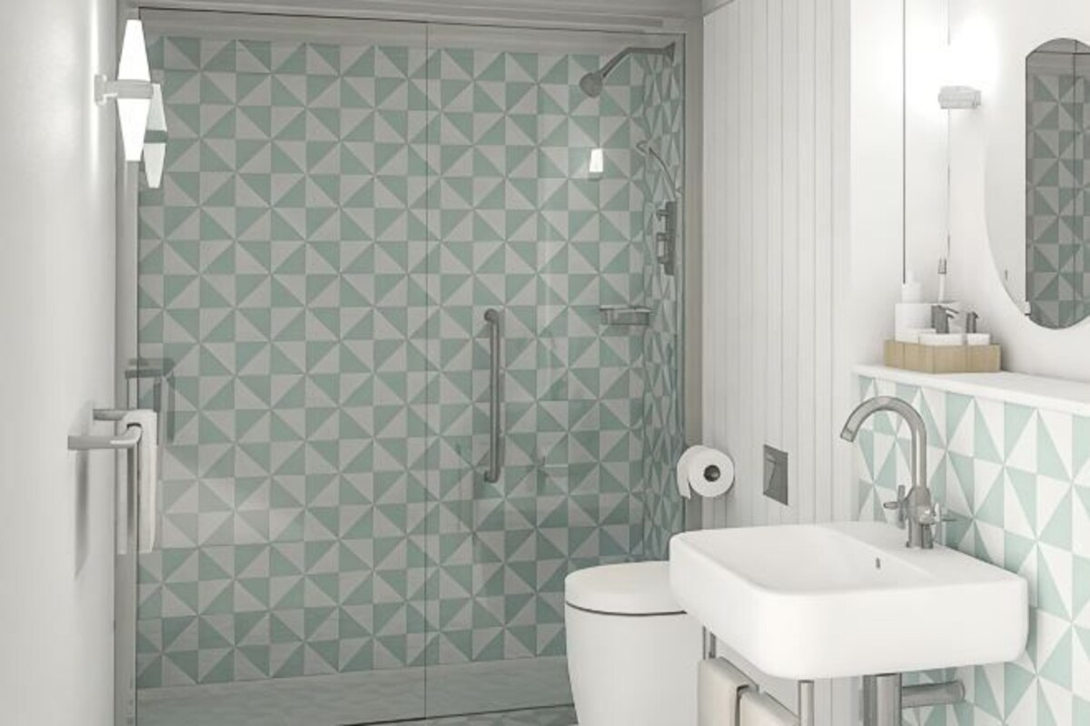 A bathroom with a geometric tile pattern, a toilet, a sink, and a shower.