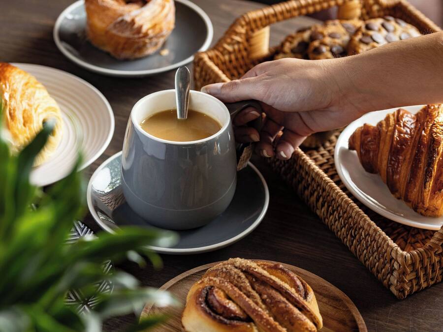 A table with pastries and a cup of coffee.
